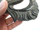 a person holding a small metal object in their hand
