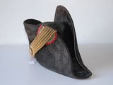 a black hat with a red ribbon on top of it