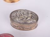 a silver box with a picture on it next to a red apple