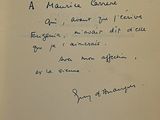 an old book with a handwritten poem on it sitting on a table