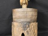 an old wooden bell with a bird on top of it on a black background