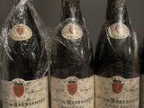 six bottles of wine wrapped in plastic sitting on a table