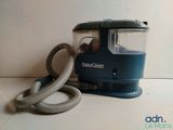 a blue and gray vacuum cleaner sitting on a counter