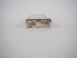 a close up of a silver watch sitting on top of a white surface