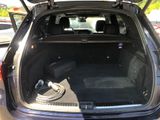 the back of a car with its trunk open and a hose in the trunk