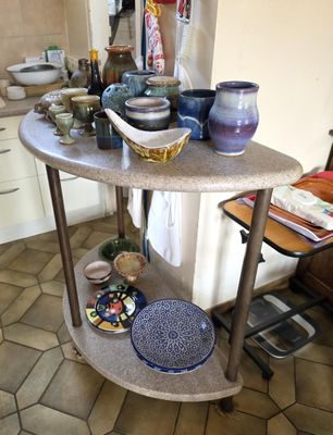 a table with plates and bowls on it in the kitchen