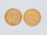 two gold sovereigns, one with the head of a man and one with a woman