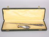 a silverware set in a green case on a white surface