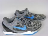 grey and blue sneakers on a white surface with a white background