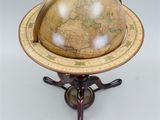 an antique globe on a stand with a wooden base