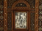 a wooden box with a painting of a man and a woman on it