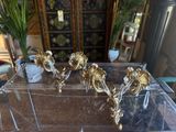 a glass table with a bunch of gold decorations on top of it