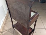 a wooden chair that is sitting on a tile floor