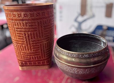 two cups sitting on a table next to each other