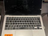 a laptop computer sitting on a table with a price tag on it