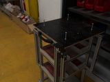 a small table with a black top in the middle of a room