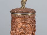 an image of a small bronze statue on top of a wooden table