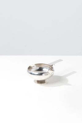 a spoon with a spoon rest on it on a table