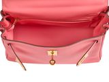 a close up of a pink purse with a gold handle