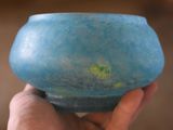 a person holding a blue bowl in their hand
