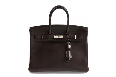 a brown leather handbag with a key on the handle