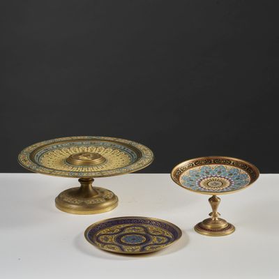 three pieces of brass and glass on a white table