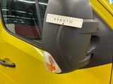 a yellow van with a sticker on it ' s side mirror