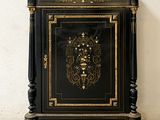 an image of a black and gold cabinet with a clock on top of it