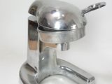 a silver object that is on a white surface