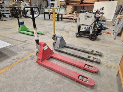 a forklift in the middle of a warehouse with other equipment