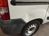 a white van parked in a garage with its door open