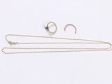 a pair of gold and silver jewellery on a white background