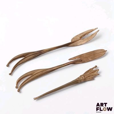 three wooden utensils sitting next to each other on a white surface