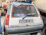 a man that is standing next to a car in a garage
