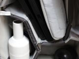 a black and white bag with a bottle and a white vase inside of it
