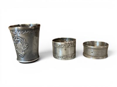 three silver cups with designs on them sitting next to each other