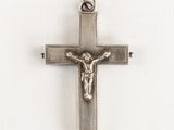silver cross with jesus on it on a white background