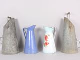several different types of vases are lined up against a white wall