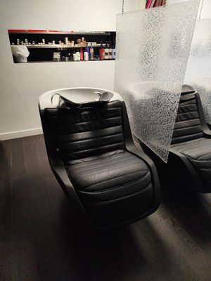 two black chairs in the corner of a room