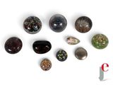 many different types of stones on a white surface