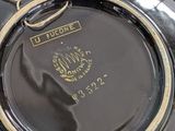 a close up of a black plate with a gold rim