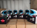 boxes of helmets are stacked on top of each other in a shipping container