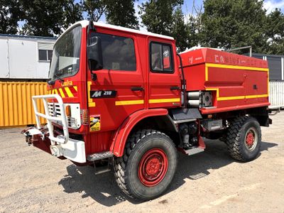 a red fire truck that is parked in a parking lot