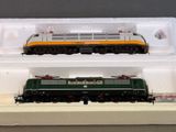 two model trains sitting on display in a box