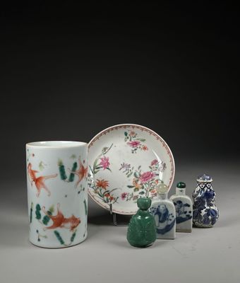 a group of vases and a plate on a table