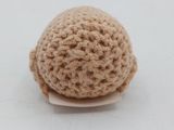 a small crochet ball sitting on top of a plate