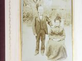 an old picture of a man and a woman with a dog