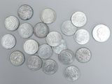 a pile of silver coins on a gray surface