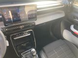 the interior of a car with a touch screen and a steering wheel