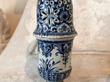 a blue and white vase sitting on top of a table